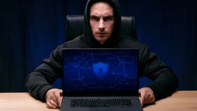 A Hacker Trying to Hack Through a Business Using His Laptop