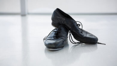 A pair of worn-out school shoes