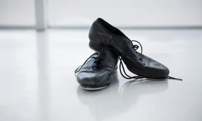 A pair of worn-out school shoes